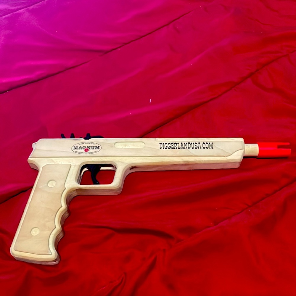 Wooden rubber band gun. (Not real)